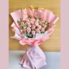Soft pink rose bouquet with baby’s breath and delicate fillers, wrapped in pastel pink paper for an elegant floral gift