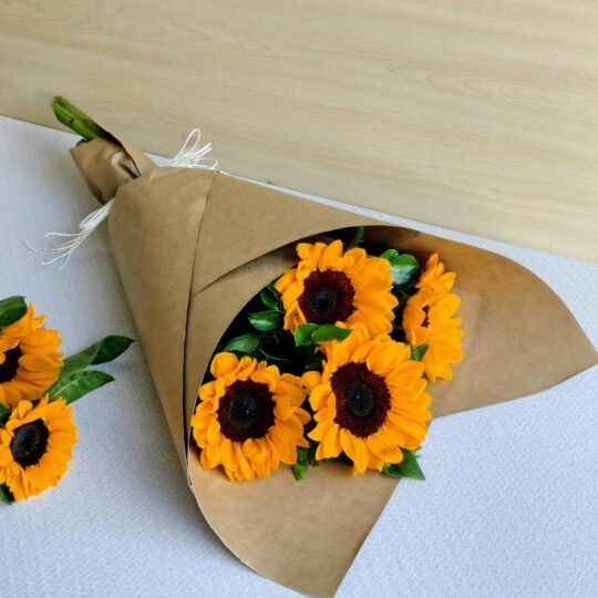 Fresh sunflower bouquet wrapped in brown kraft paper by premium florist in Bangalore