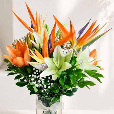 Birds of paradise and lily flower arrangement in glass vase with same day delivery in Bangalore