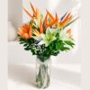 Birds of paradise and lily flower arrangement in glass vase with same day delivery in Bangalore