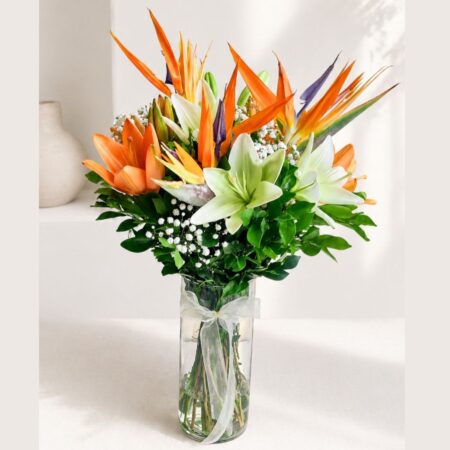 Birds of paradise and lily flower arrangement in glass vase with same day delivery in Bangalore