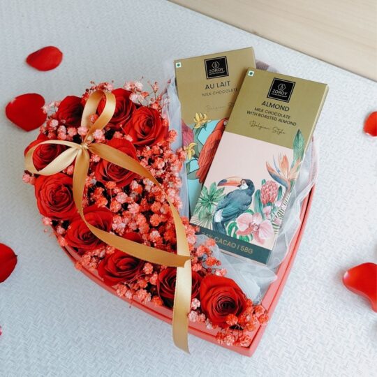 Heart-shaped box of fresh red roses with Belgian chocolates, Valentine flower delivery in Bangalore.