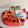 Heart-shaped box of fresh red roses with Belgian chocolates, Valentine flower delivery in Bangalore.
