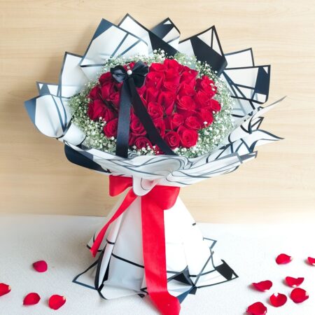 Red rose bouquet with white fillers for Valentine’s Day flower delivery in Bangalore by FreshKnots