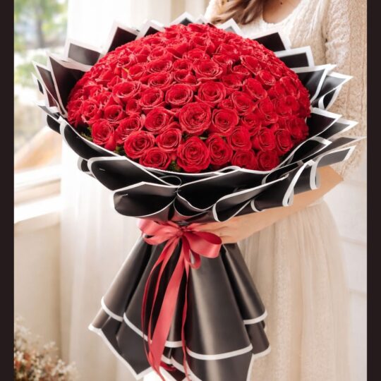Luxury red rose bouquet with premium black wrapping by FreshKnots, ideal for same day flower delivery and romantic gifting in Bangalore.