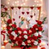 Romantic couple figurine with red rose flower arrangement for Valentine’s Day delivery in Bangalore