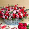 Luxury floral basket arrangement with red roses, pink roses, carnations, fillers and eucalyptus by FreshKnots Bangalore.