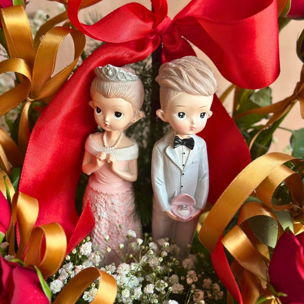 Premium red rose heart arrangement with couple figurines by Bangalore florist