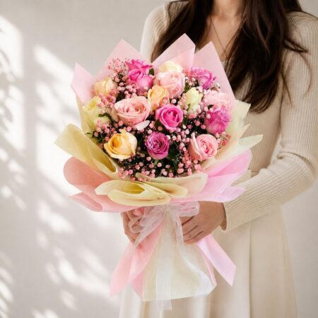 Fresh pastel rose bouquet wrapped in pink and cream paper for same day flower delivery in Bangalore by FreshKnots