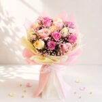 Fresh pastel rose bouquet wrapped in pink and cream paper for same day flower delivery in Bangalore by FreshKnots