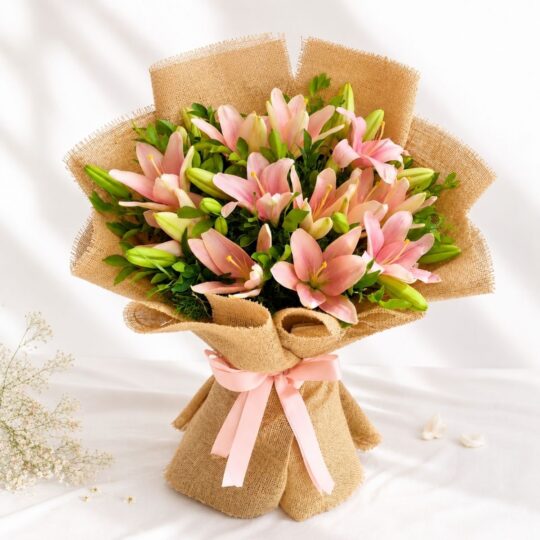 Pink lily bouquet wrapped in jute with green foliage – perfect for birthday gifts, anniversary flowers, and same day flower delivery in Bengaluru.
