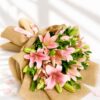 Pink lily bouquet wrapped in jute with green foliage – perfect for birthday gifts, anniversary flowers, and same day flower delivery in Bengaluru.