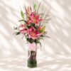 Premium pink lilies in glass vase arrangement with fresh flowers for luxury flower delivery in Bangalore.