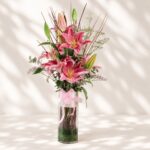 Premium pink lilies in glass vase arrangement with fresh flowers for luxury flower delivery in Bangalore.