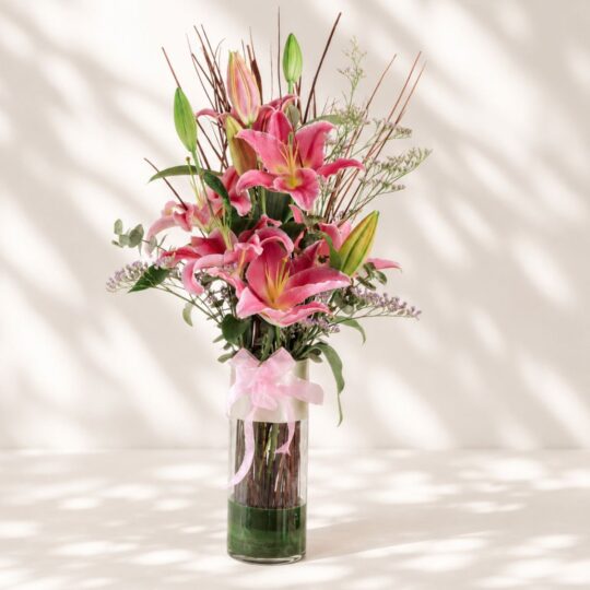 Premium pink lilies in glass vase arrangement with fresh flowers for luxury flower delivery in Bangalore.