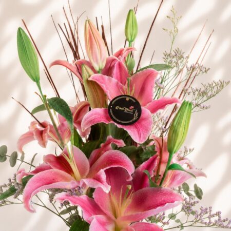 Premium pink lilies in glass vase arrangement with fresh flowers for luxury flower delivery in Bangalore.