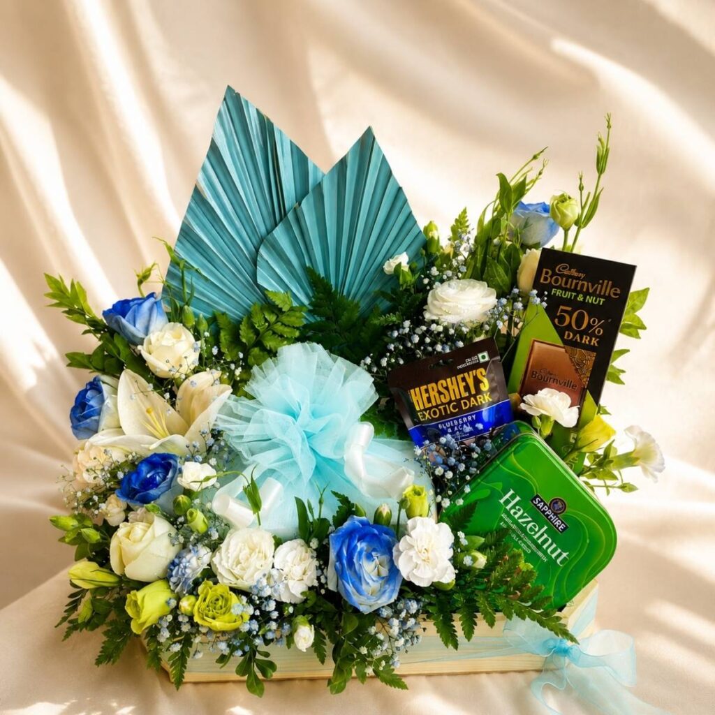 Luxury cake and flower hamper with fresh flowers and gourmet treats for premium gifting in Bangalore.