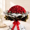 Luxury bouquet of 100 fresh red roses with white fillers, handcrafted by FreshKnots Bangalore.