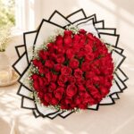Luxury bouquet of 100 fresh red roses with white fillers, handcrafted by FreshKnots Bangalore.
