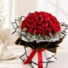 Luxury bouquet of 100 fresh red roses with white fillers, handcrafted by FreshKnots Bangalore.