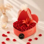 Luxury heart-shaped flower box with fresh red roses and red lily for Valentine's Day, anniversary and romantic flower delivery in Bangalore.
