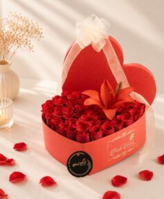 Luxury heart-shaped flower box with fresh red roses and red lily for Valentine's Day, anniversary and romantic flower delivery in Bangalore.