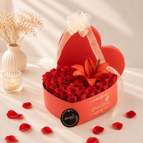 Luxury heart-shaped flower box with fresh red roses and red lily for Valentine's Day, anniversary and romantic flower delivery in Bangalore.