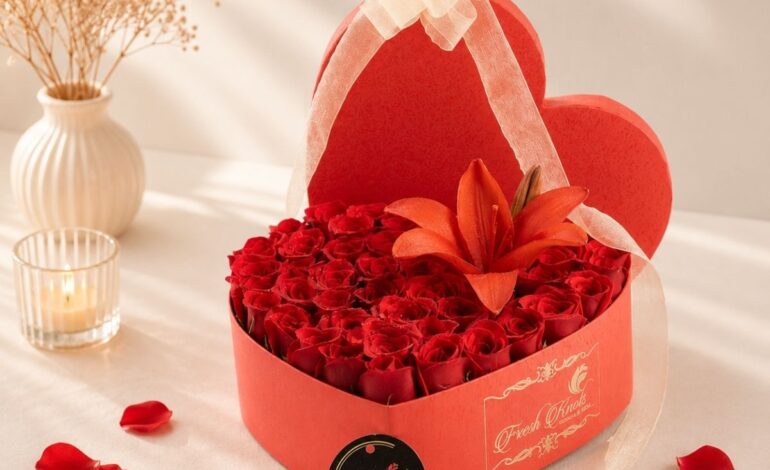 Luxury heart-shaped flower box with fresh red roses and red lily for Valentine's Day, anniversary and romantic flower delivery in Bangalore.