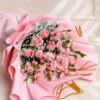 Soft pink rose bouquet with baby’s breath and delicate fillers, wrapped in pastel pink paper for an elegant floral gift