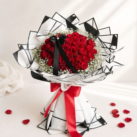 Red rose bouquet with white fillers for Valentine’s Day flower delivery in Bangalore by FreshKnots