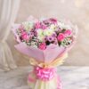 Pink rose and white chrysanthemum bouquet with baby’s breath wrapped in blush pink paper and satin ribbon.