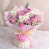 Pink rose and white chrysanthemum bouquet with baby’s breath wrapped in blush pink paper and satin ribbon.