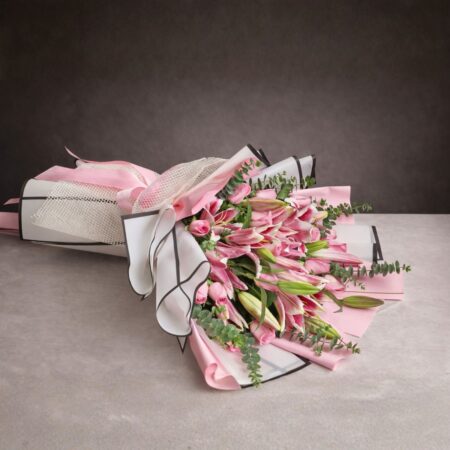 Luxury pink lily and rose hand-tied bouquet with pastel wrapping and satin ribbon, premium fresh flower arrangement for birthday and anniversary gift.