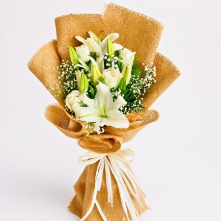 Elegant white lily and rose bouquet with baby’s breath in burlap wrapping