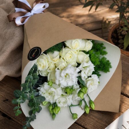 Premium white flower bouquet in European hand tied style with seasonal blooms by FreshKnots Bangalore.