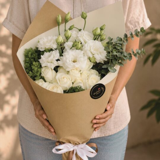 Premium white flower bouquet in European hand tied style with seasonal blooms by FreshKnots Bangalore.