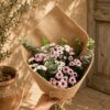 Pastel daisy chrysanthemum bouquet with eucalyptus and rustic jute wrapping for online flower delivery in Bangalore.