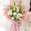 White lily bouquet with baby’s breath in blush pink luxury wrapping for flower delivery Bangalore