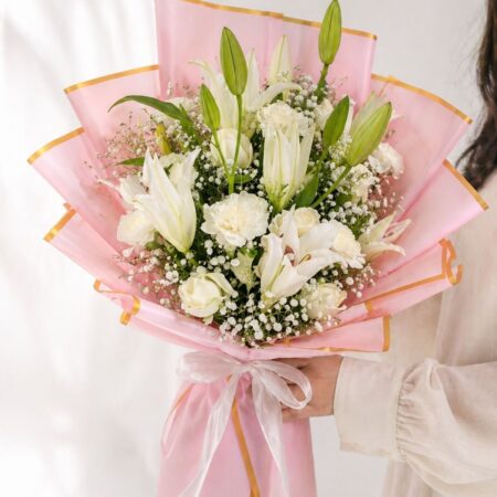 White lily bouquet with baby’s breath in blush pink luxury wrapping for flower delivery Bangalore