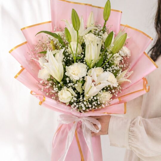 White lily bouquet with baby’s breath in blush pink luxury wrapping for flower delivery Bangalore