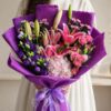 Luxury pink lily and hydrangea bouquet in purple wrap for flower delivery in Bangalore