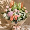 Luxury peach and blush flower bouquet with premium seasonal blooms and elegant wrapping for online flower delivery in Bangalore.