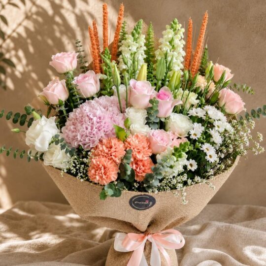 Luxury peach and blush flower bouquet with premium seasonal blooms and elegant wrapping for online flower delivery in Bangalore.