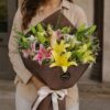 Luxury lily bouquet with seasonal flowers in elegant hand tied wrapping for online flower delivery in Bangalore.