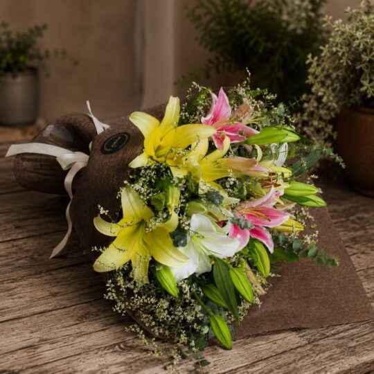 Luxury lily bouquet with seasonal flowers in elegant hand tied wrapping for online flower delivery in Bangalore.