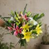 Luxury lily bouquet with seasonal flowers in elegant hand tied wrapping for online flower delivery in Bangalore.