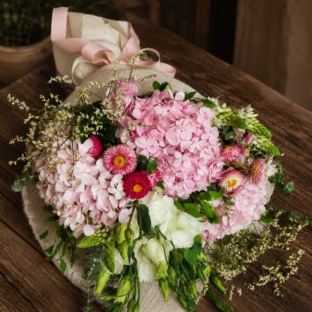 Luxury pink hydrangea bouquet with seasonal flowers and earthy minimalist wrapping for online flower delivery in Bangalore.