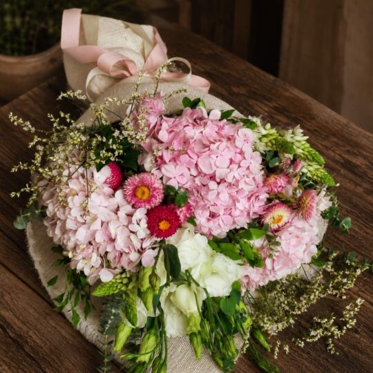 Luxury pink hydrangea bouquet with seasonal flowers and earthy minimalist wrapping for online flower delivery in Bangalore.