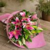 Premium pink lily bouquet with seasonal flowers and earthy wrapping for online flower delivery in Bangalore.