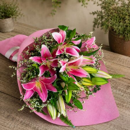 Premium pink lily bouquet with seasonal flowers and earthy wrapping for online flower delivery in Bangalore.